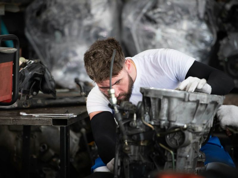 men-repairing-car-engine-in-auto-repair-shop-selective-focus-.jpg